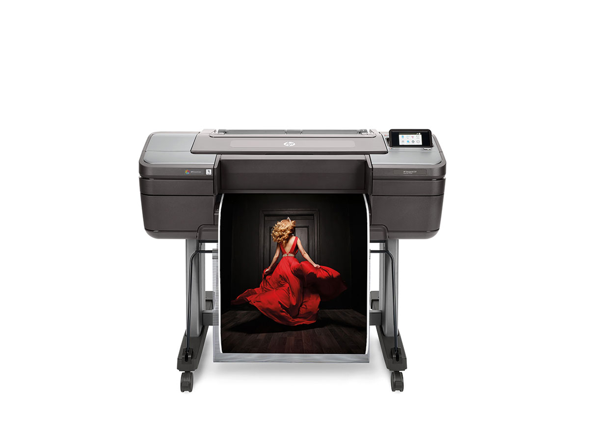 HP DesignJet Z6 prints a high-resolution fashion photograph of a woman in a red dress on a professional wide-format printer.